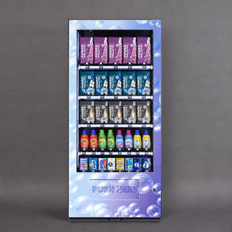 A tall automatic vending machine with a purple and blue bubble-patterned front panel, stocked with Powerade drinks in purple, blue, and white bottles, set against a solid gray background.