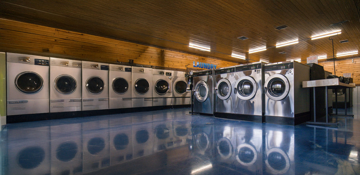 Row of commercial washing machines in a laundromat
