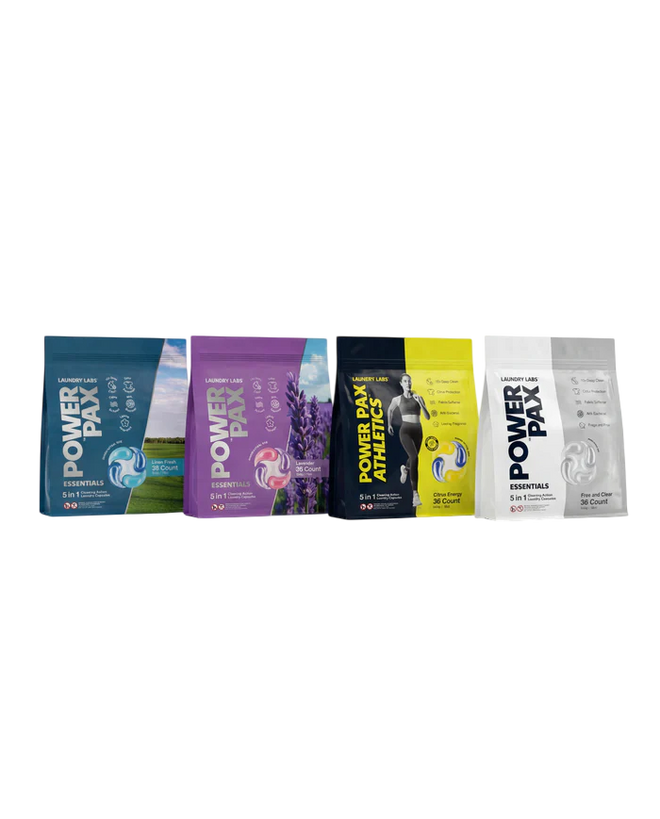 Four Power Play sports drink pouches lined up horizontally on a plain white background. The pouches are in different colorways: blue, purple, black and yellow, and white.